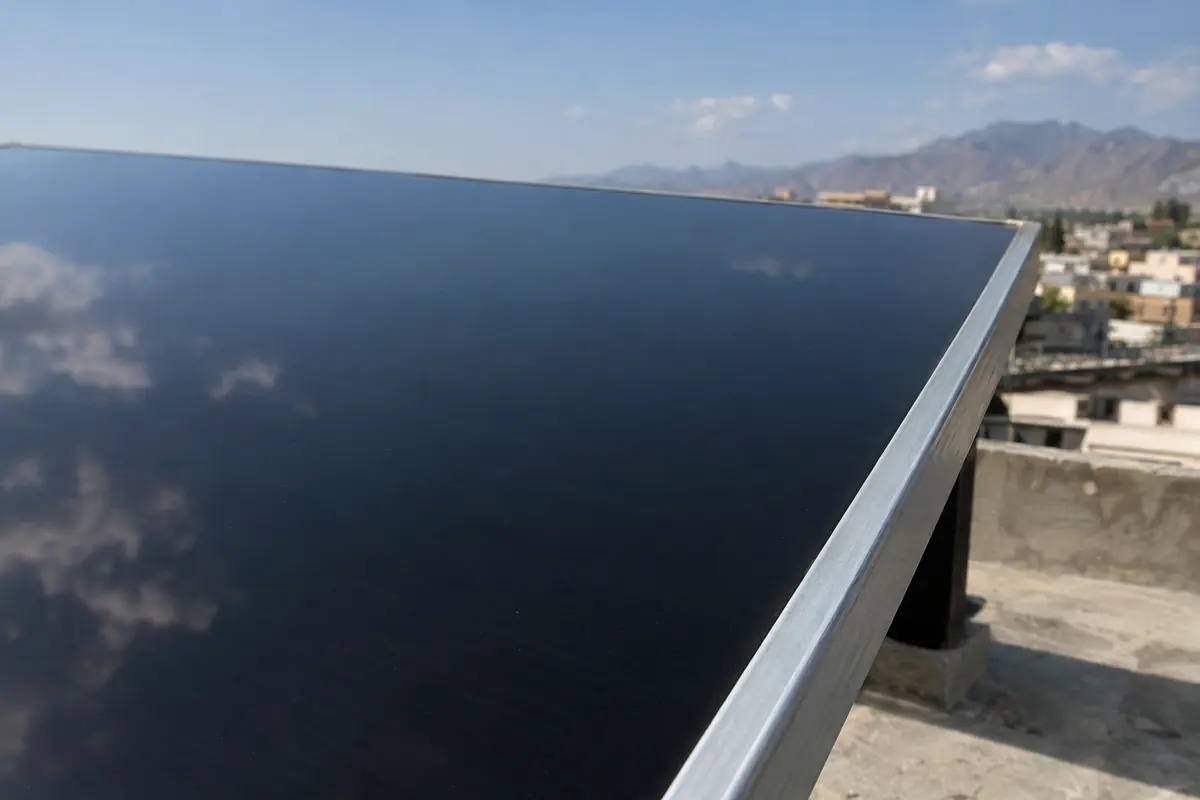 Close-up of an all-black monocrystalline solar panel with a busbar-free front